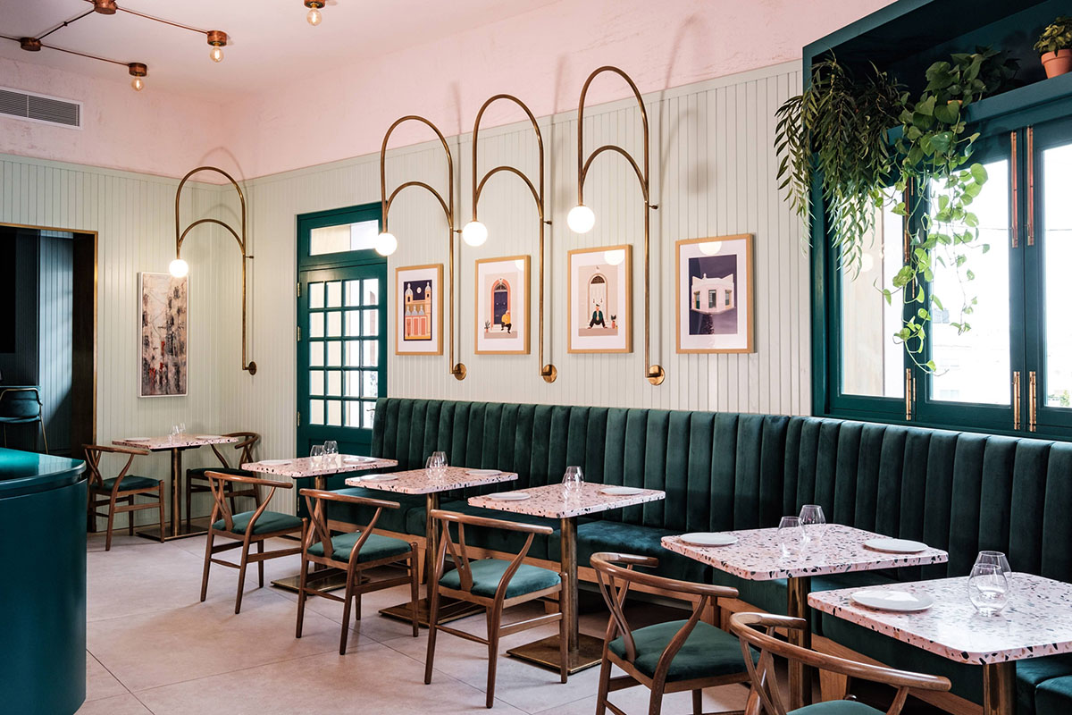 Mizzi Studio marks this restaurant with pink rendered facade and emerald green timber doors in Malta