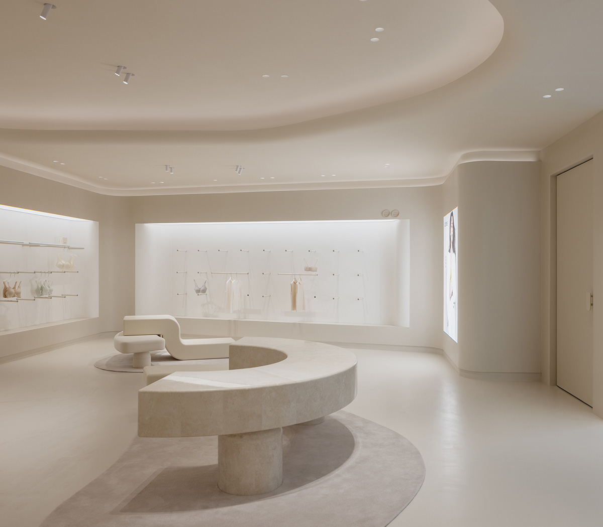 Store interiors by Sò Studio features soft beige tones to give the feeling of 