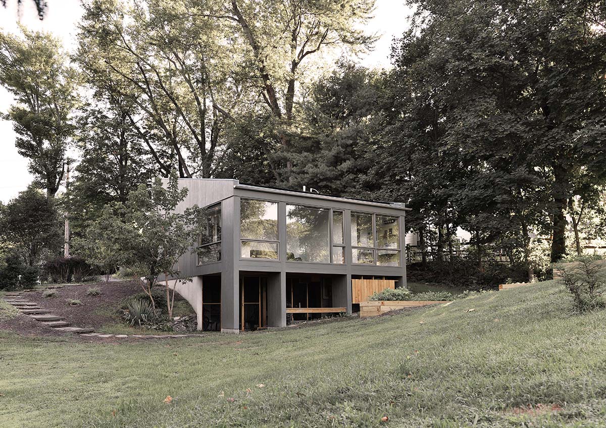 An artist's studio floats and illuminates in the landscape in Germantown