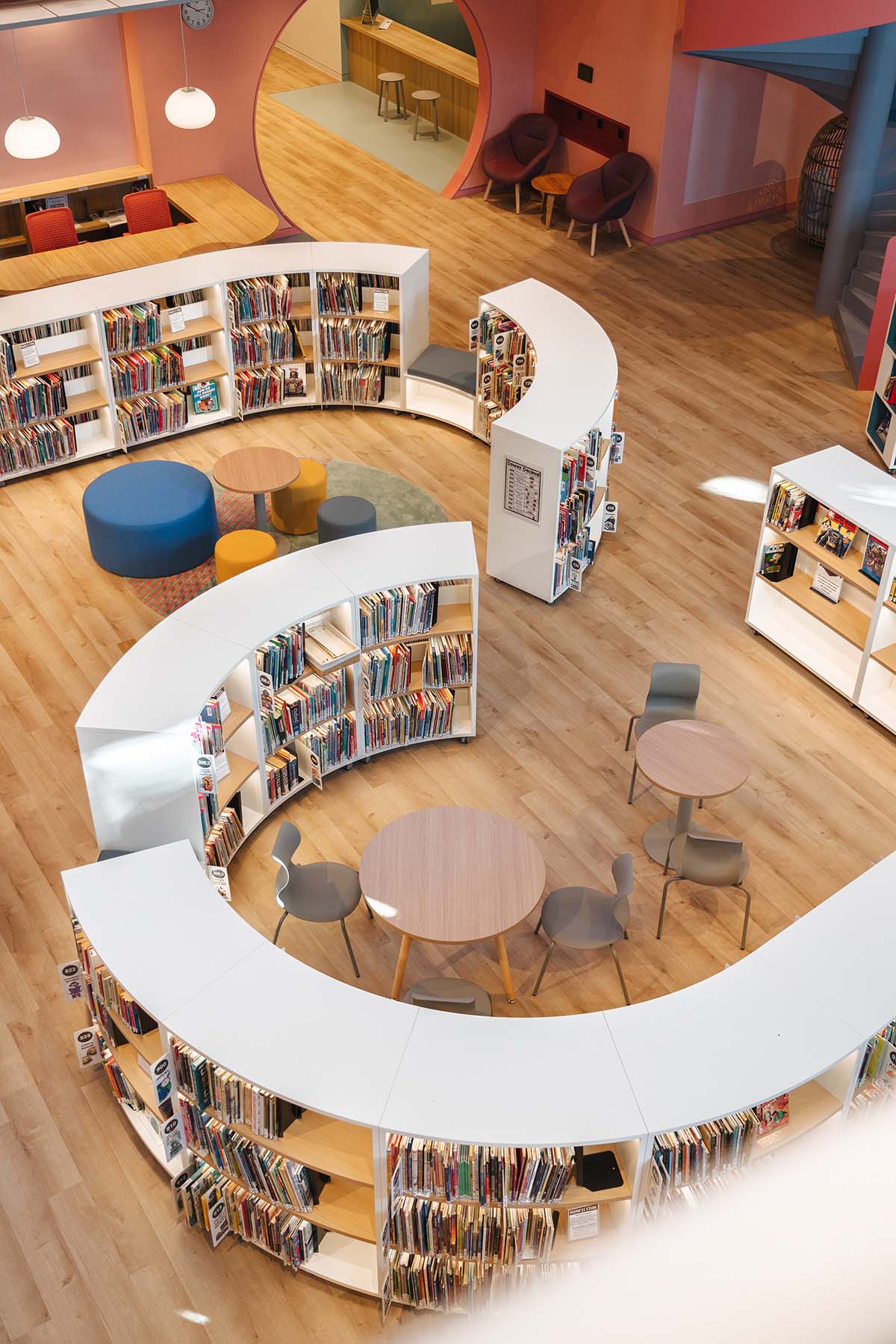 Elementary school library features vibrant colors and playful elements, resembling a fairy tale 