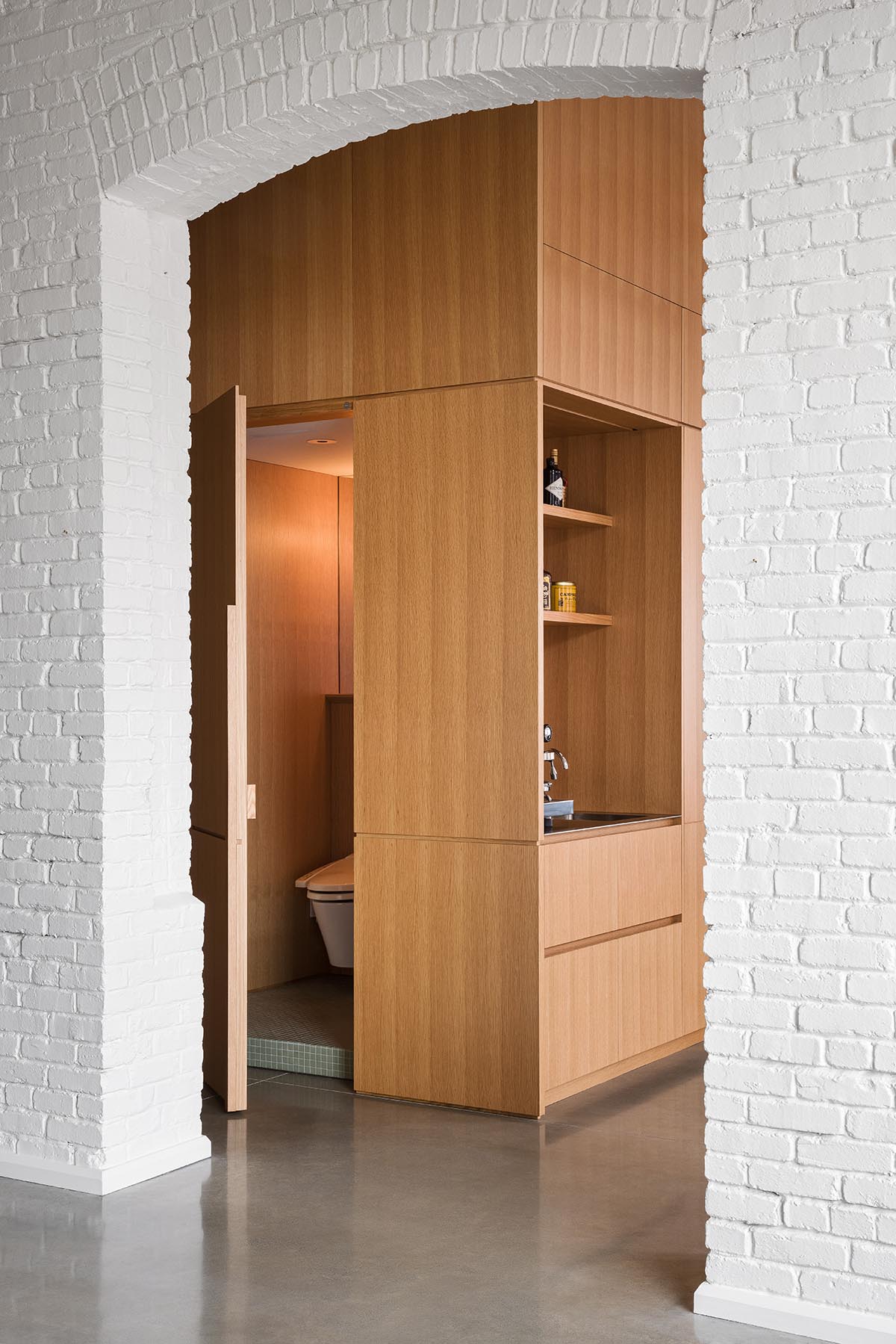 La Firme renovates historic mid-19th-century building with brick walls and oak cabinets in Montreal 