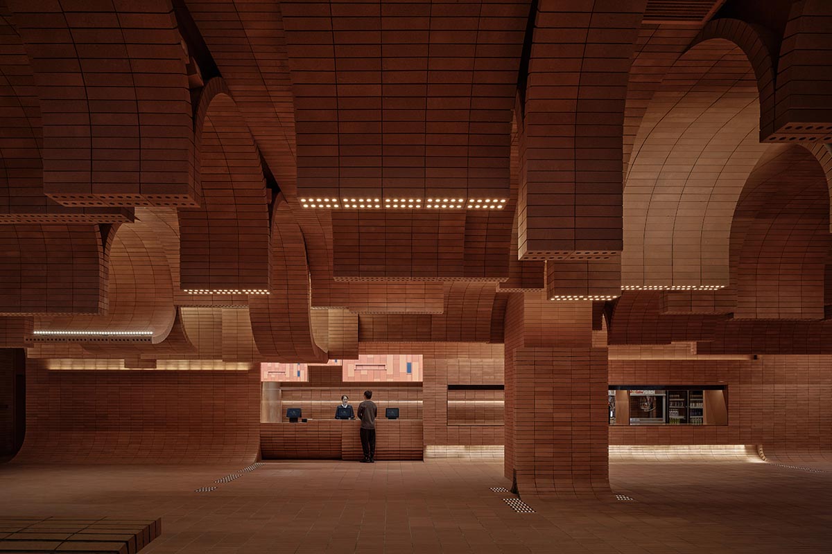 One Plus Partnership adds layered bricks to a cinema interior to resemble waves in Haikou