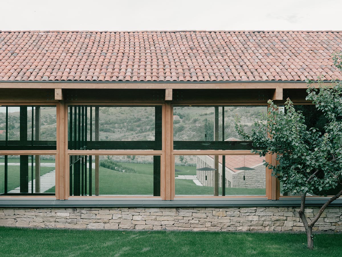 The stone and wood Tbilisi residence integrates architecture with the natural landscape