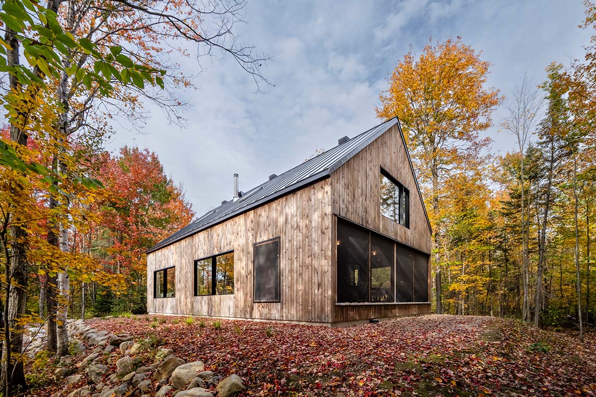 Country home is a wooden shelter that brings tranquility in the heart of the forest in Canada
