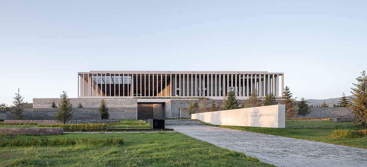 Grey brick walls wrap a factory building referencing to local construction methods in China 