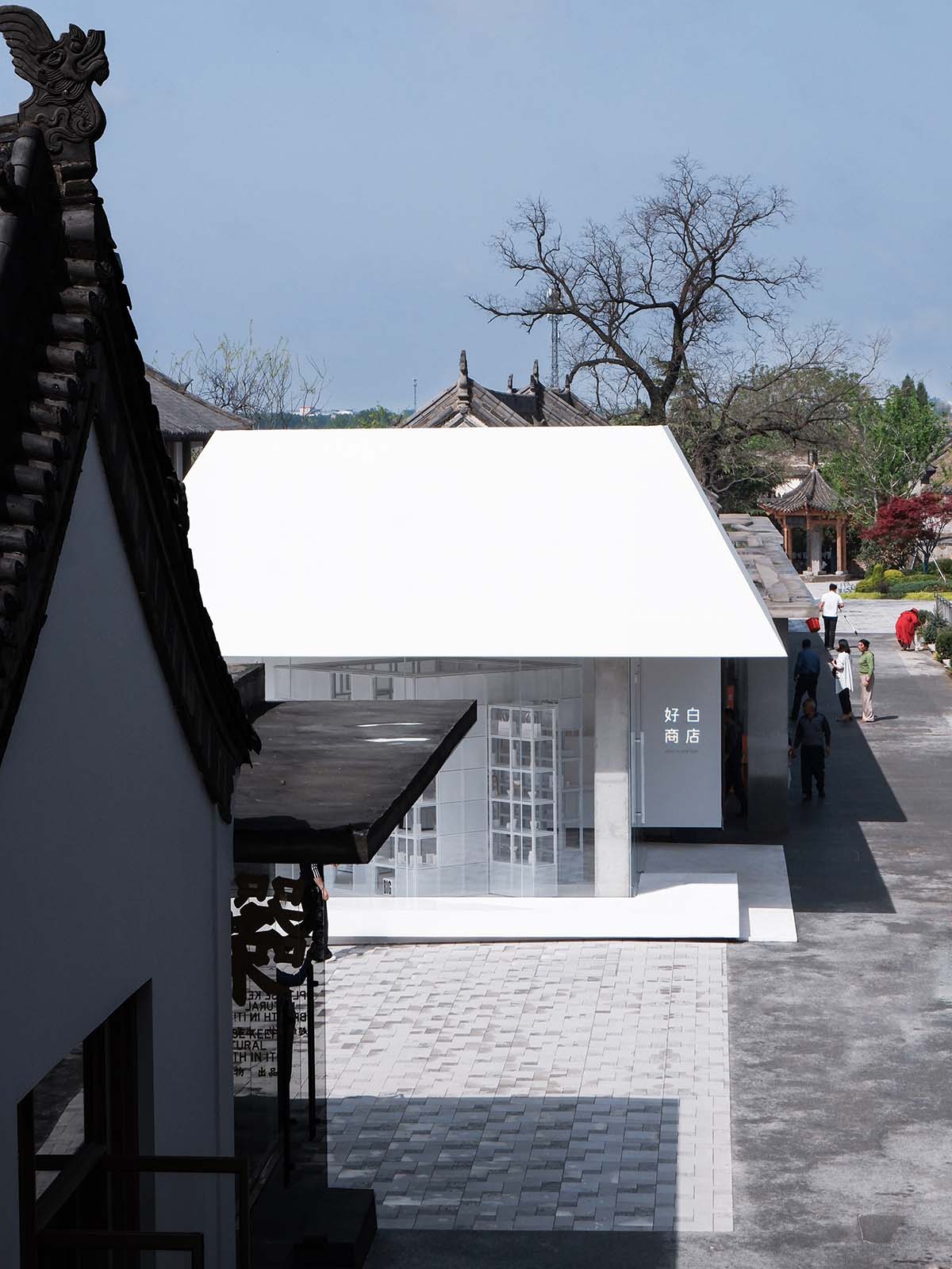 A shop is attached to Beijing historic Hutong houses with white-colored skin