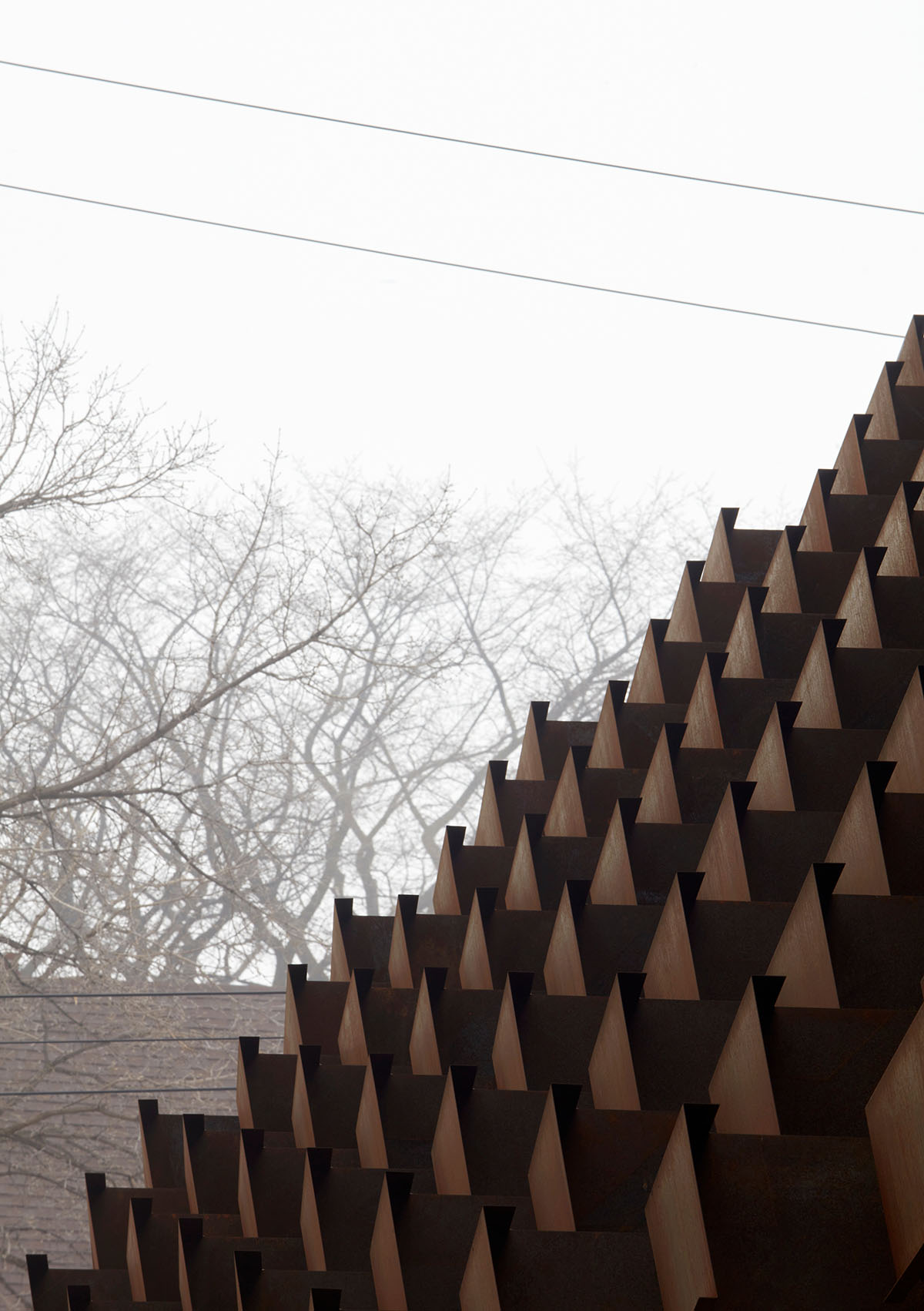 Weathered steel weil wraps the façade of Veil House in to resist snowfalls in Winnipeg