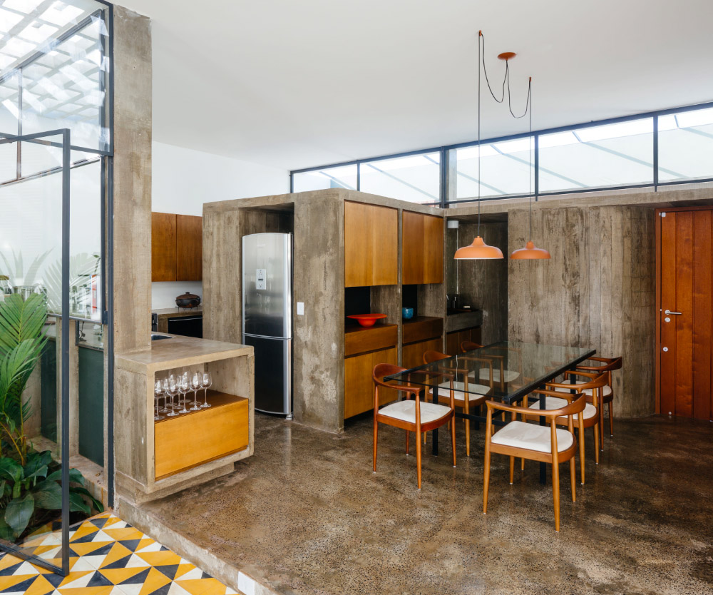 V&atilde;o designed recessed volumes and leaning red wall to offer flexible spaces for this Brazilian house