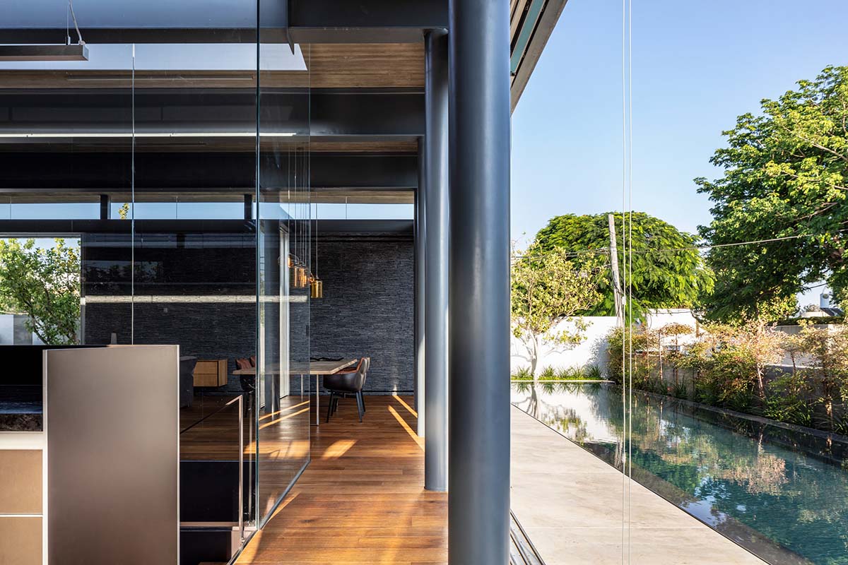 Pitsou Kedem Architects' black Pavilion House is reflected onto a linear swimming pool in Israel