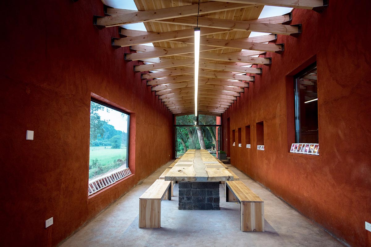 Children attend teaching courses in between red-colored free standing walls in rural village of China