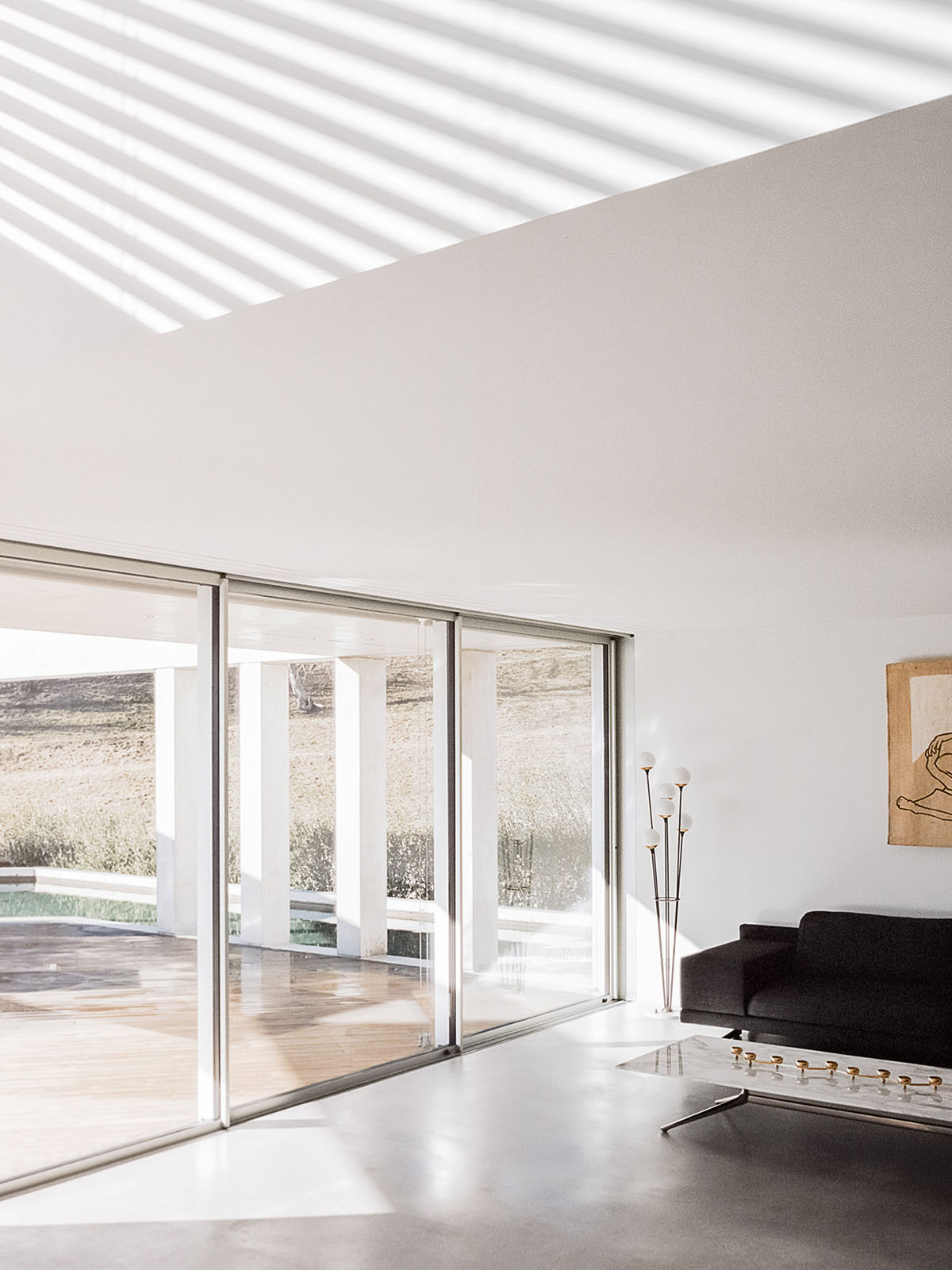 Grey concrete villa by DF_DC is characterised with trapezoidal colonnaded terrace on Comano hills