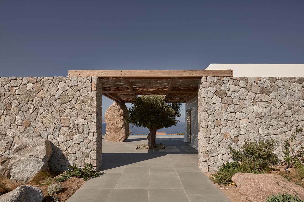 K Studio built small holiday villa with round-edged volumes and shading elements in Mykonos