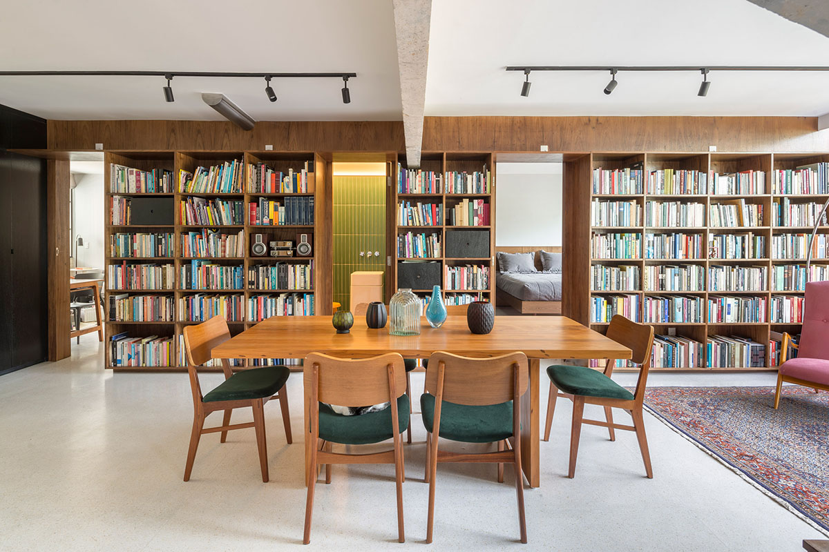 A historic Brazilian apartment has been redesigned with wooden bookcase as main divider