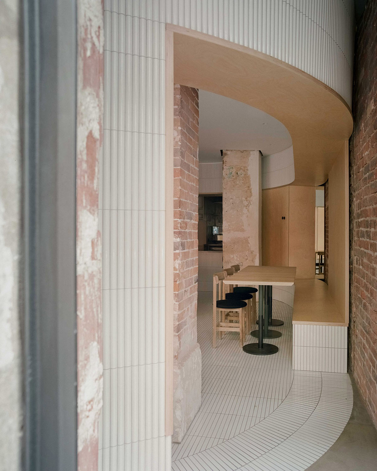 Neri&Hu-designed restaurant in Paris exposes layering material history with oblong volume inside