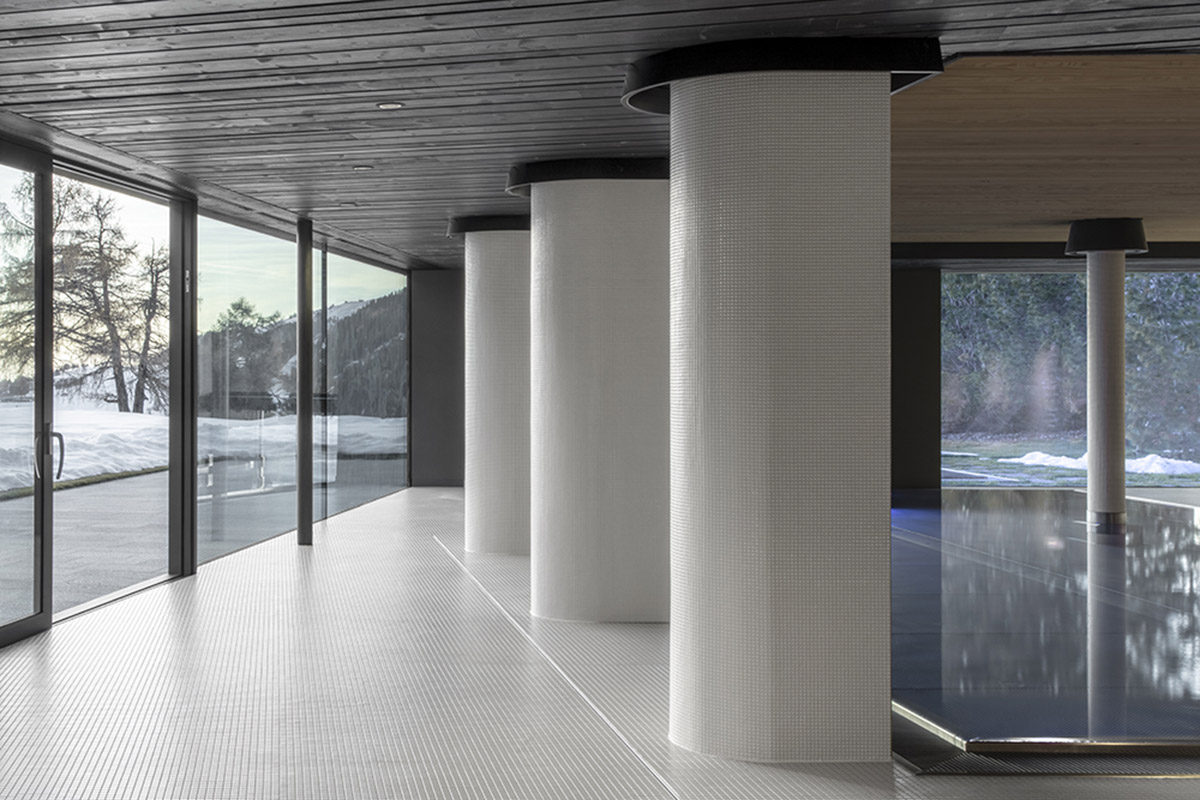 Icaro Hotel featuring wooden colonnade frames embraces alpine heritage landscape in Italy 