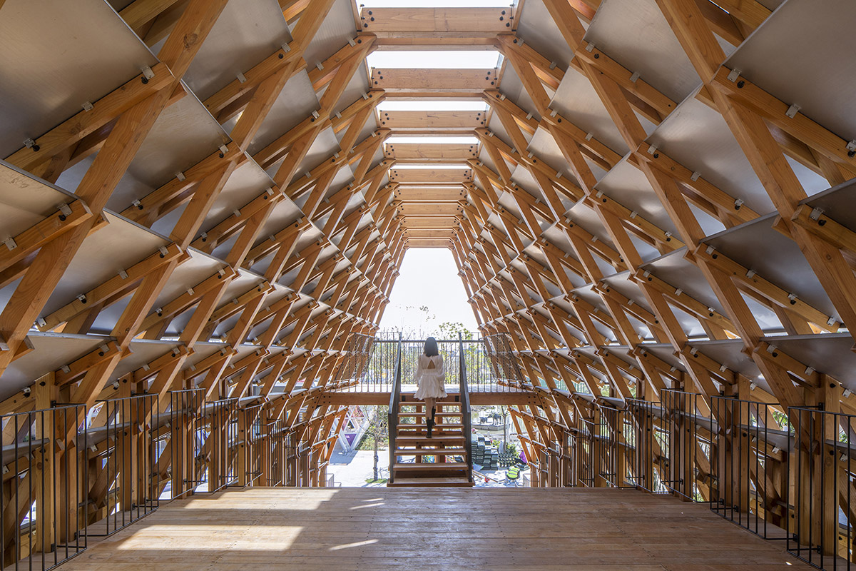 Arched timber bridge by LUO studio allows boats to pass under bridge smoothly in Gulou waterfront