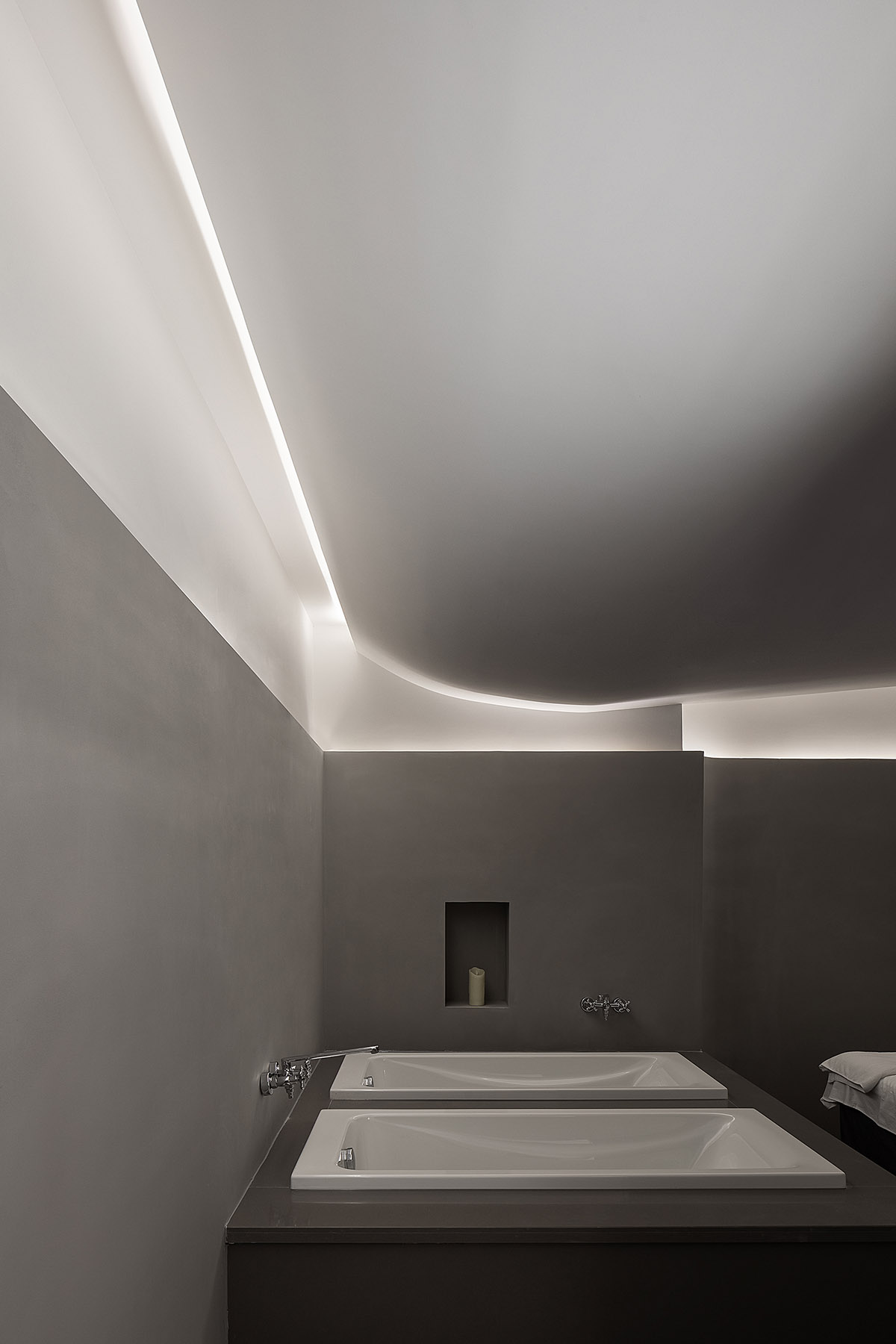 A beauty salon by AD ARCHITECTURE features dark-hued interiors drawing inspiration from cells