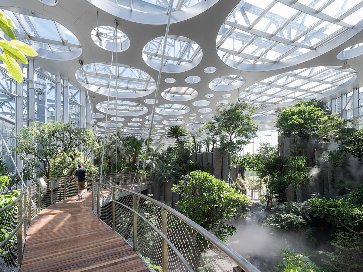 The former steelworks of a power plant are integrated with organically-shaped greenhouse pavilions