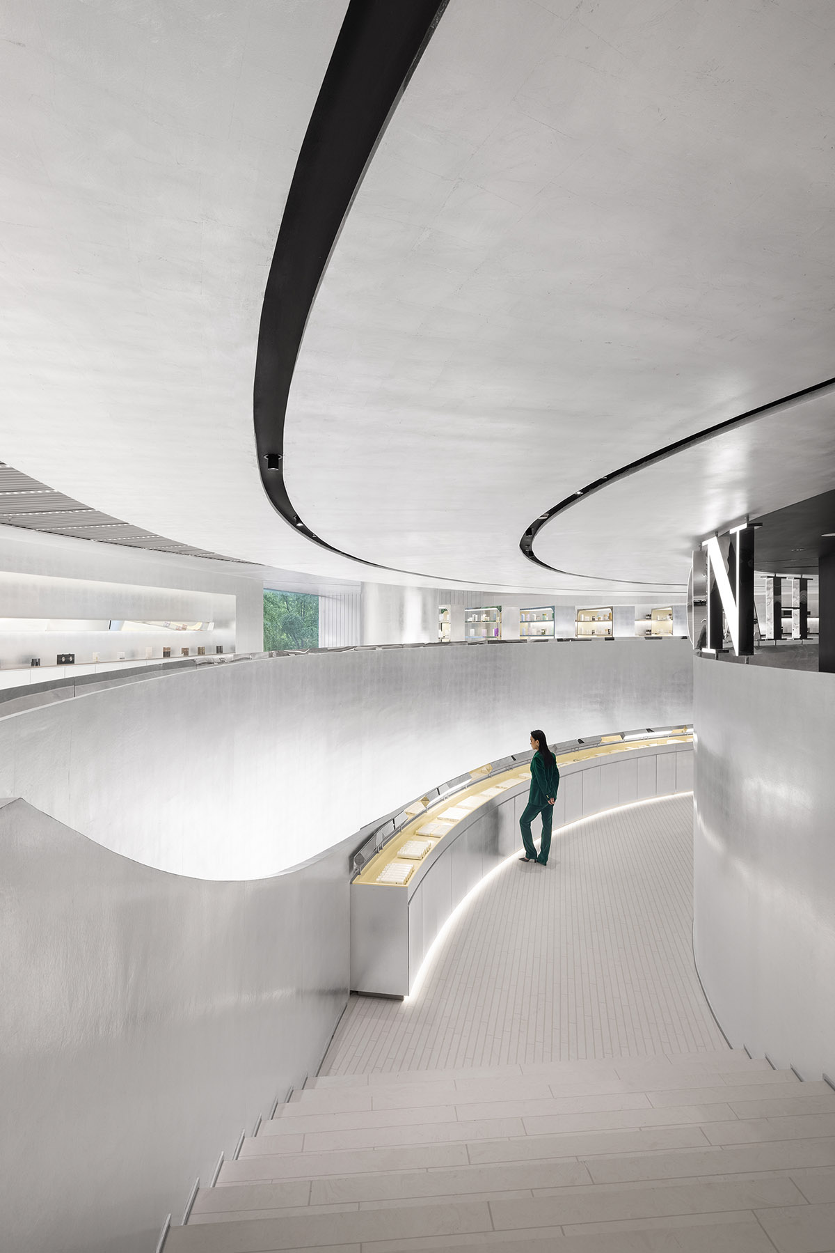 Various Associates designs beauty store with winding staircase and silver-toned interiors in Hangzhou