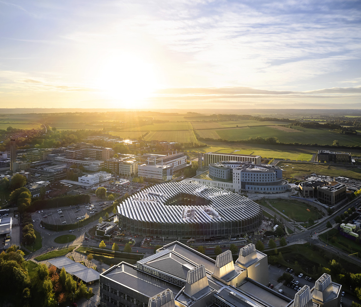 Herzog & de Meuron creates glass disc with saw-tooth roof for new AstraZeneca research centre