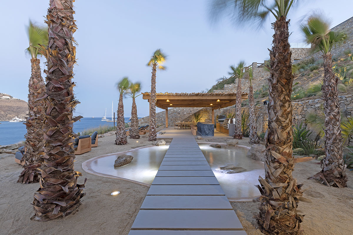 MK Design Studio designs luxurious holiday villa with creamy white walls and stone-walled terraces