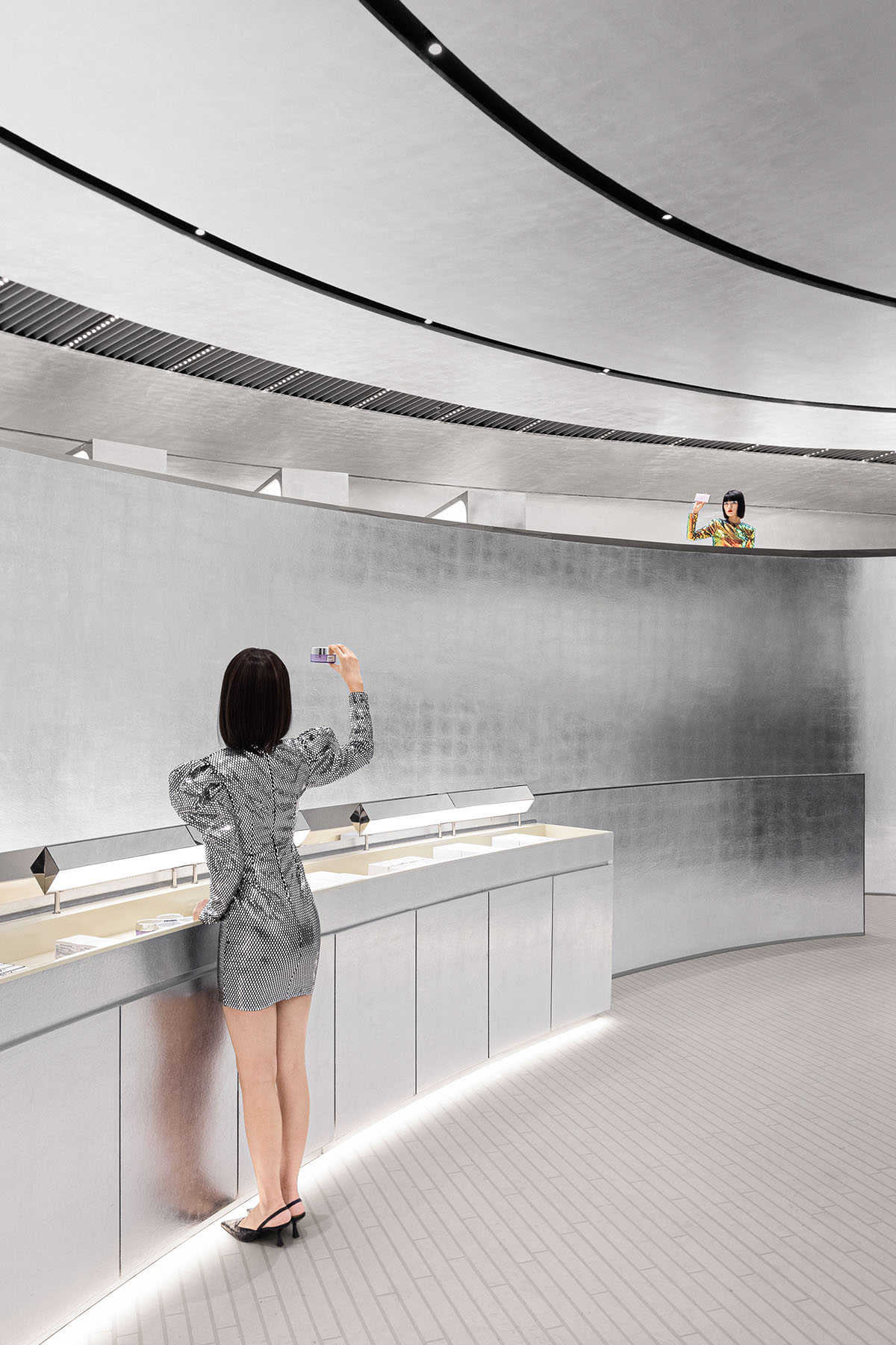 Various Associates designs beauty store with winding staircase and silver-toned interiors in Hangzhou