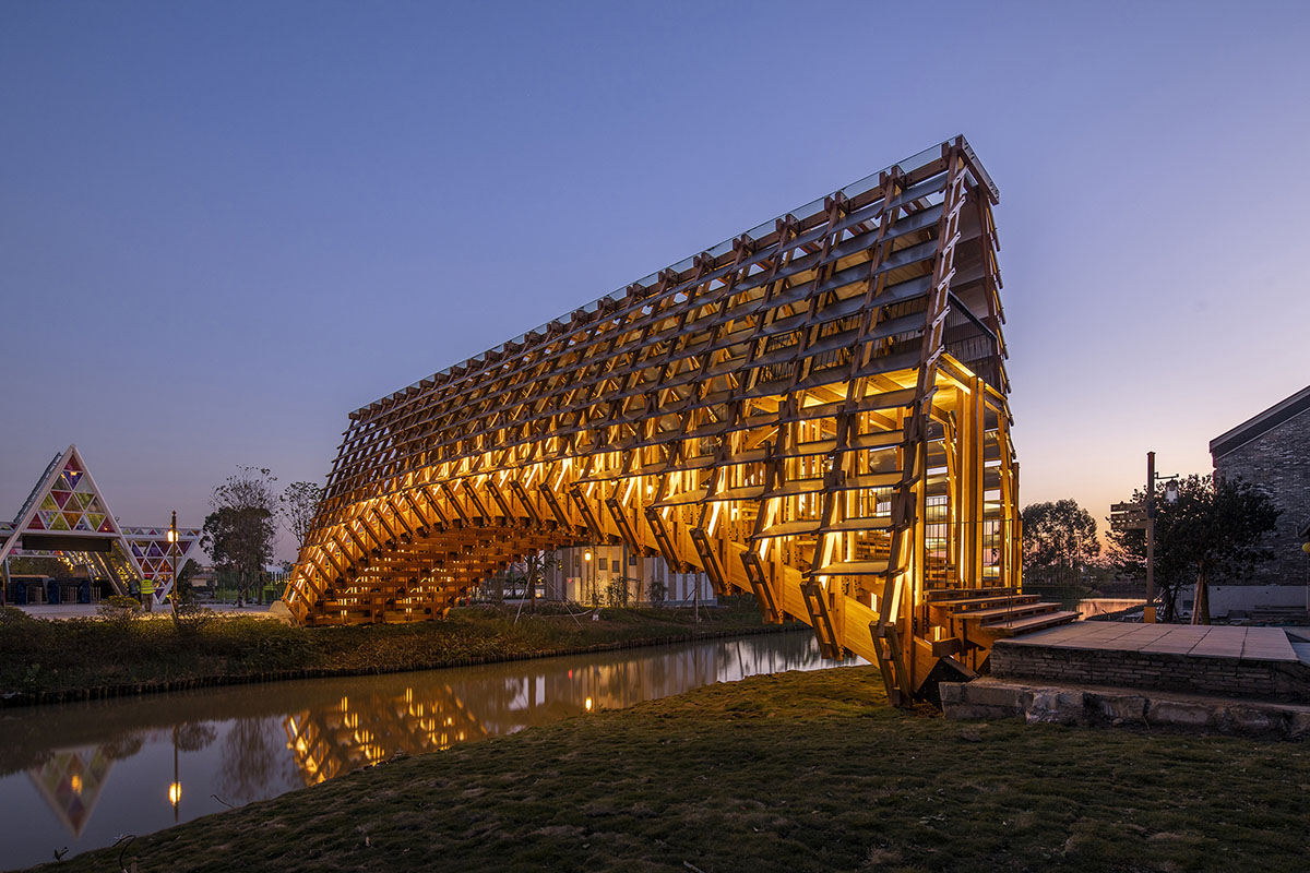 Arched timber bridge by LUO studio allows boats to pass under bridge smoothly in Gulou waterfront