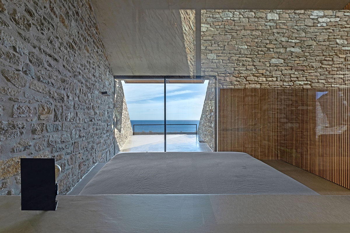 MOLD Architects used advantages of sloping land to design Ncaved house in Greece