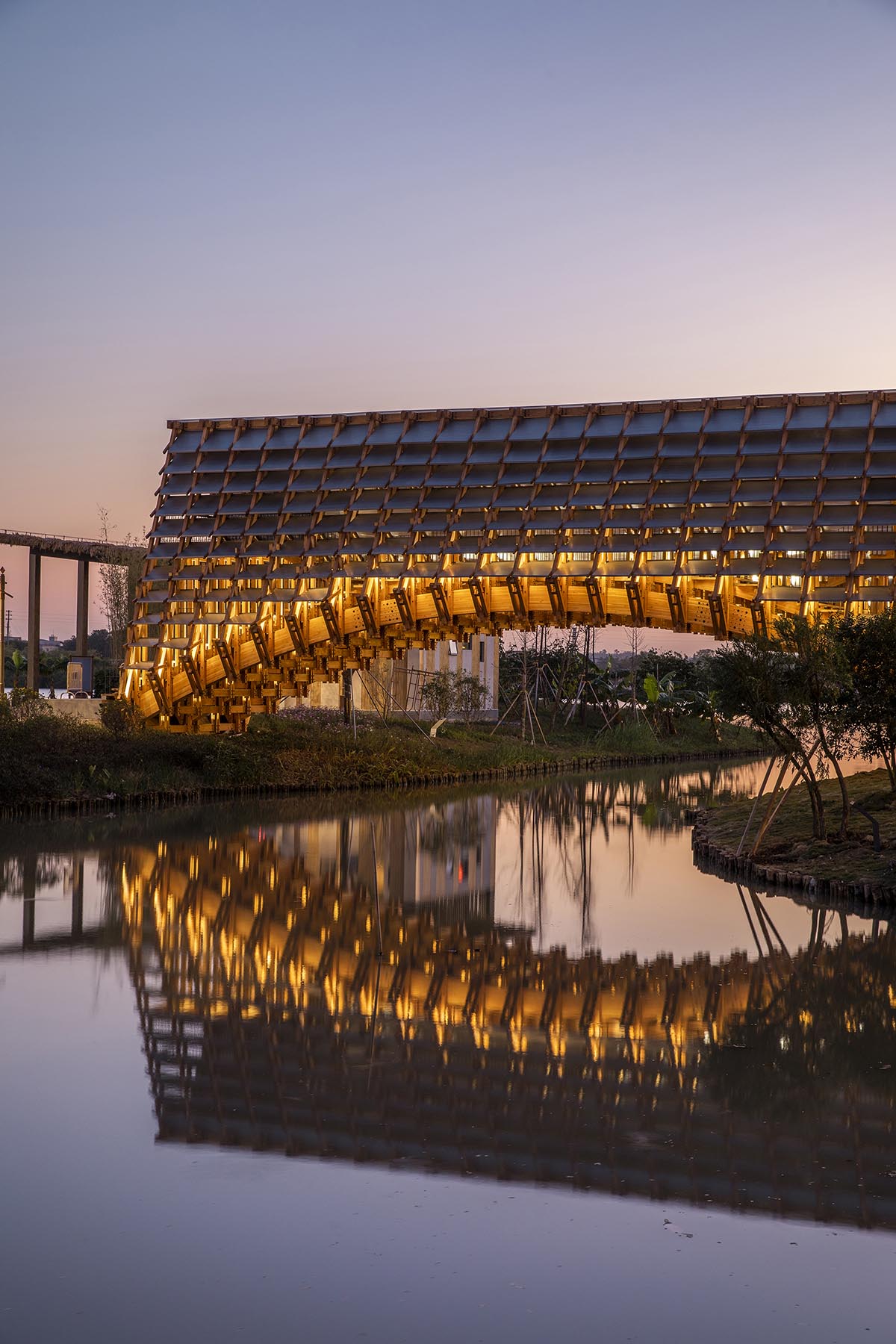 Arched timber bridge by LUO studio allows boats to pass under bridge smoothly in Gulou waterfront