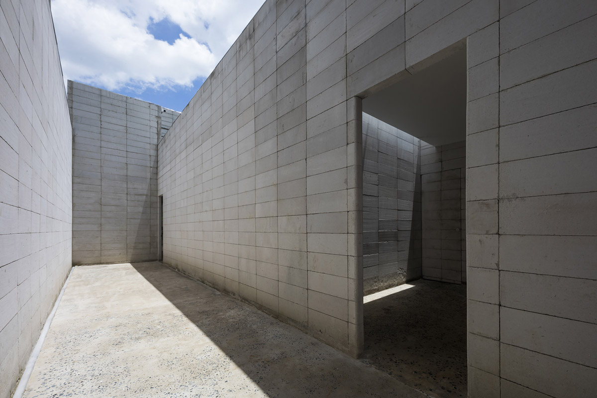 An office in Vietnam protects its own micro-climate with continuous spaces and internal courtyards