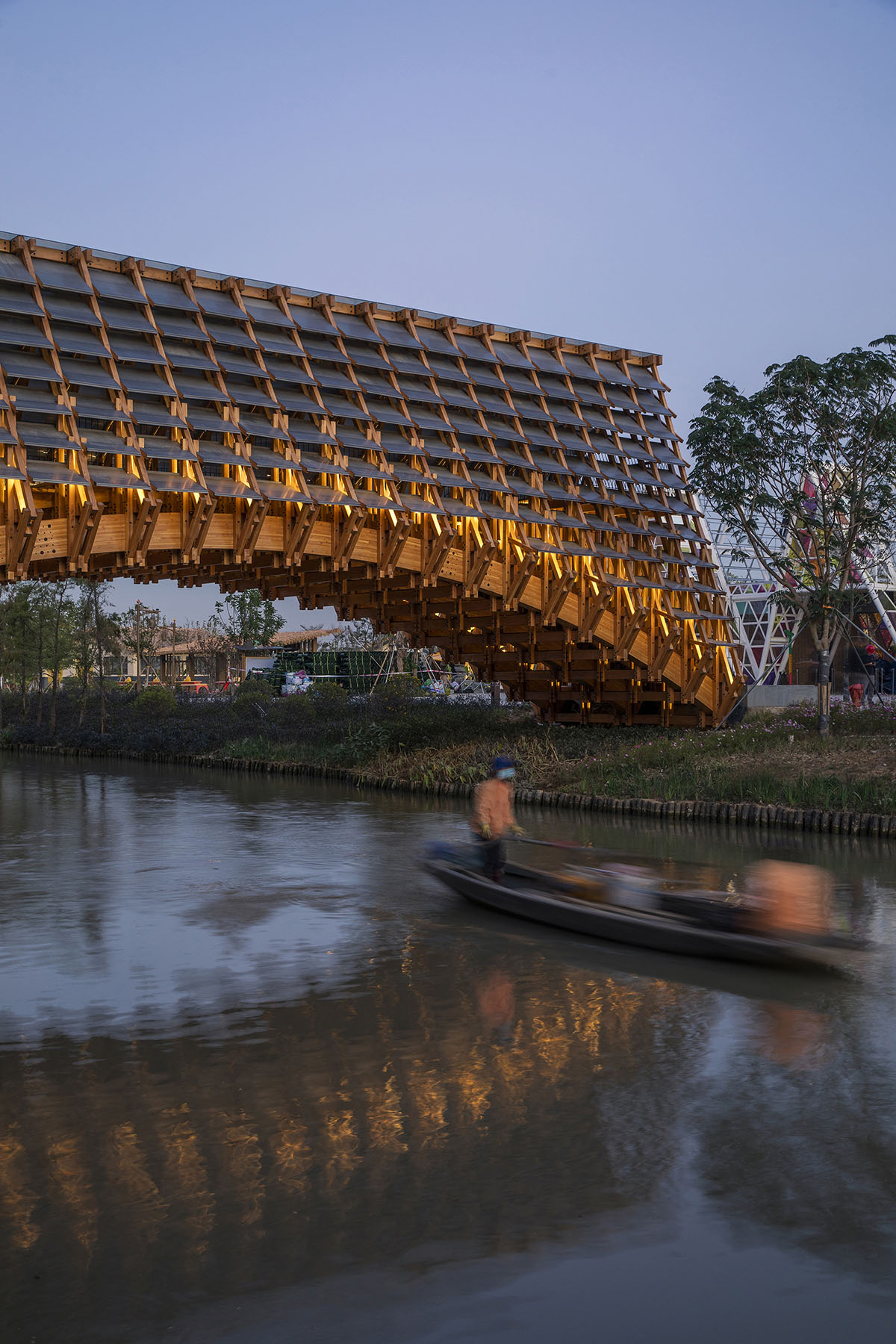 Arched timber bridge by LUO studio allows boats to pass under bridge smoothly in Gulou waterfront