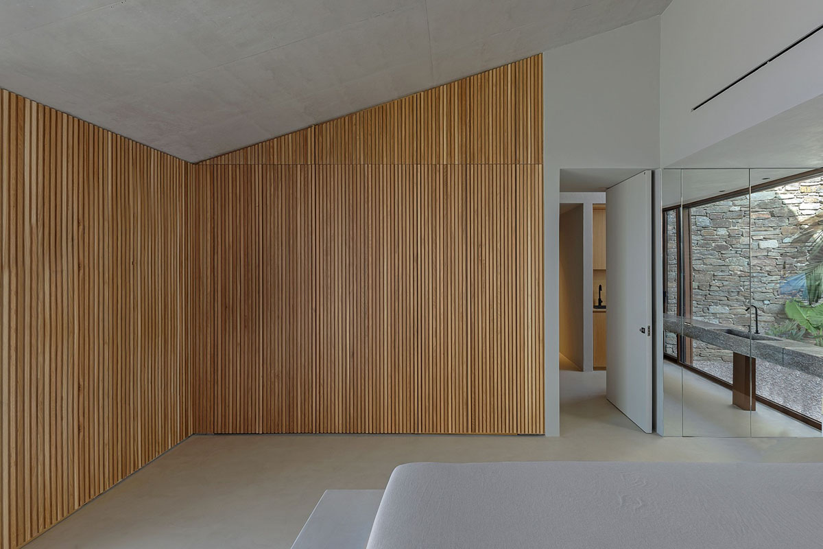 MOLD Architects used advantages of sloping land to design Ncaved house in Greece