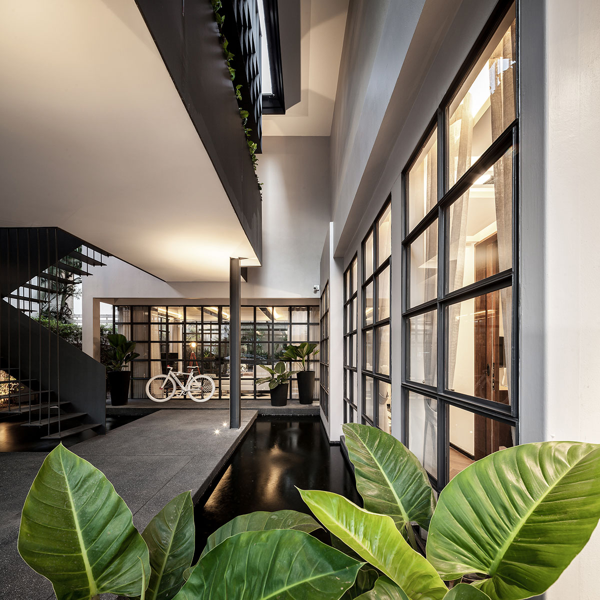 Anonym Studio renovated Bangkok’s old house with steel flower beds to create more openness