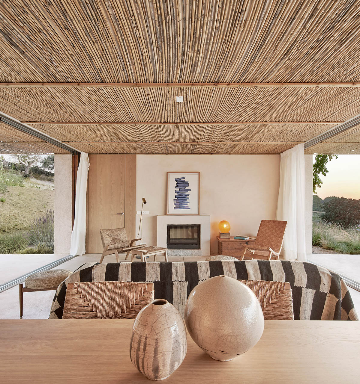 OHLAB's rural villa in Mallorca allows guests to frame natural surrounding under wattle pergola