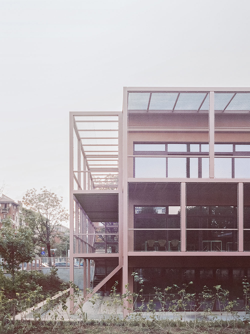 BDR bureau completes community school with pinkish steel framework in Turin