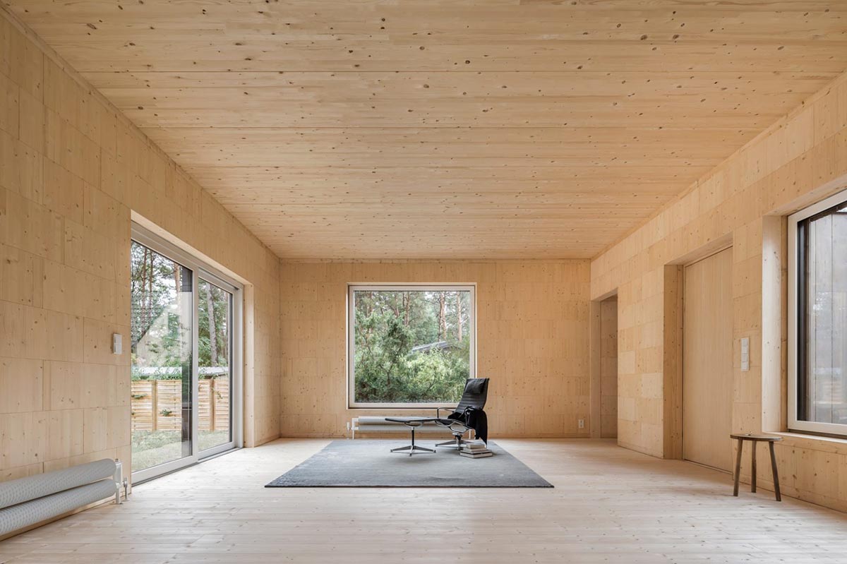 Zeller & Moye built private residence composed of interlocked timber cabins among pine trees