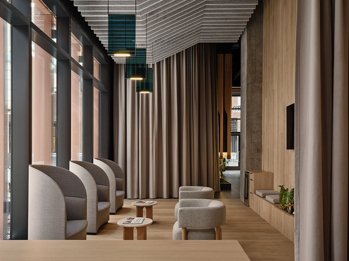 Eye care clinic features a sweeping glass block wall to disperse light in the interior