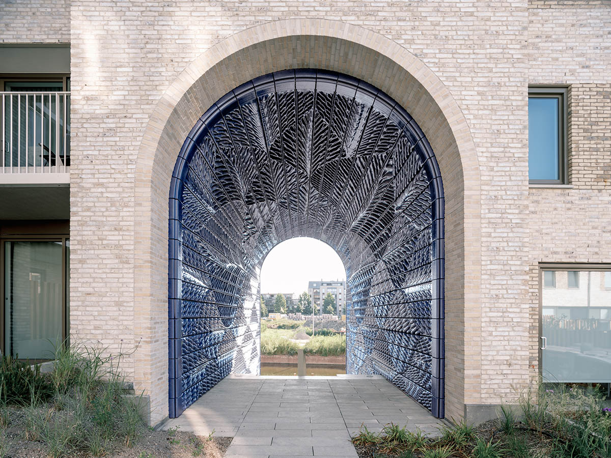 Studio RAP clads two gates of PoortMeesters residential building block in 3D blue porcelain