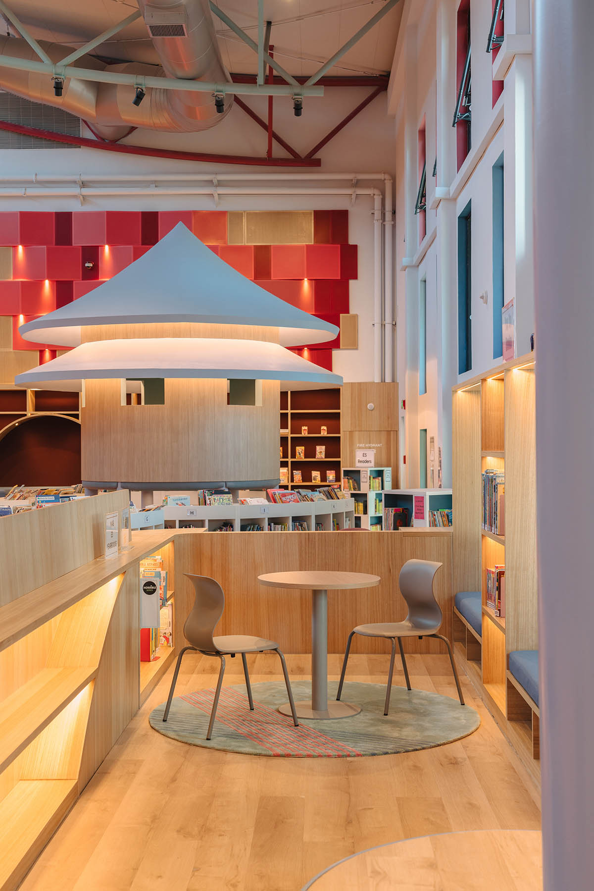 Elementary school library features vibrant colors and playful elements, resembling a fairy tale 