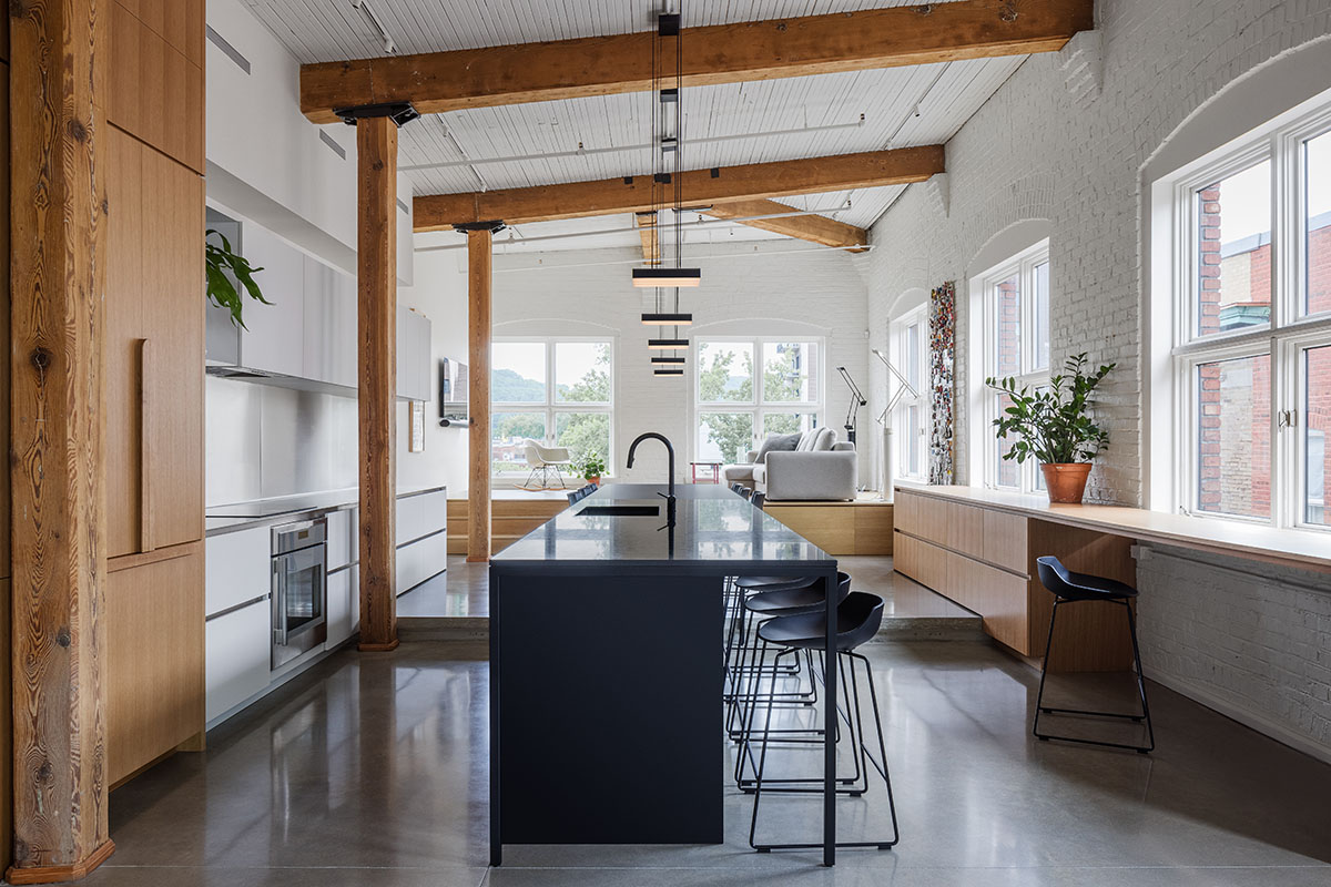 La Firme renovates historic mid-19th-century building with brick walls and oak cabinets in Montreal 