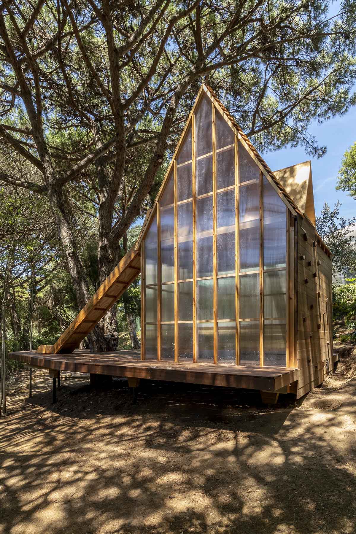 Wooden cabin by Madeiguincho is nestled among trees like an 