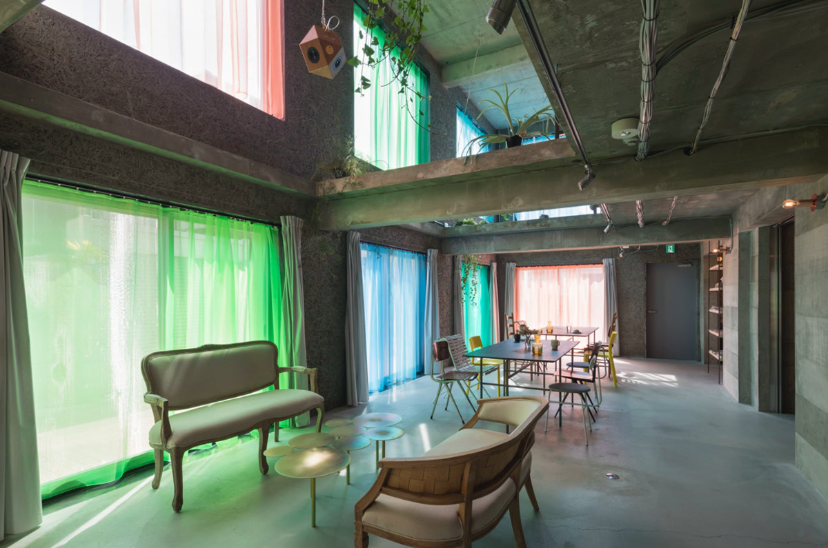 Tato Architects creates painted effect to this concrete hotel by using colourful curtains in Osaka