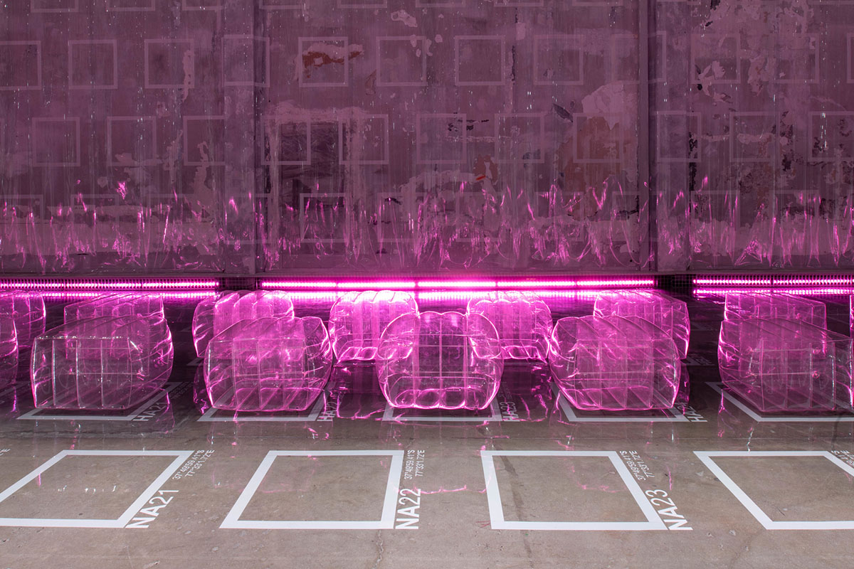 AMO filled Prada's fashion show stage with purple-lit inflatable stools