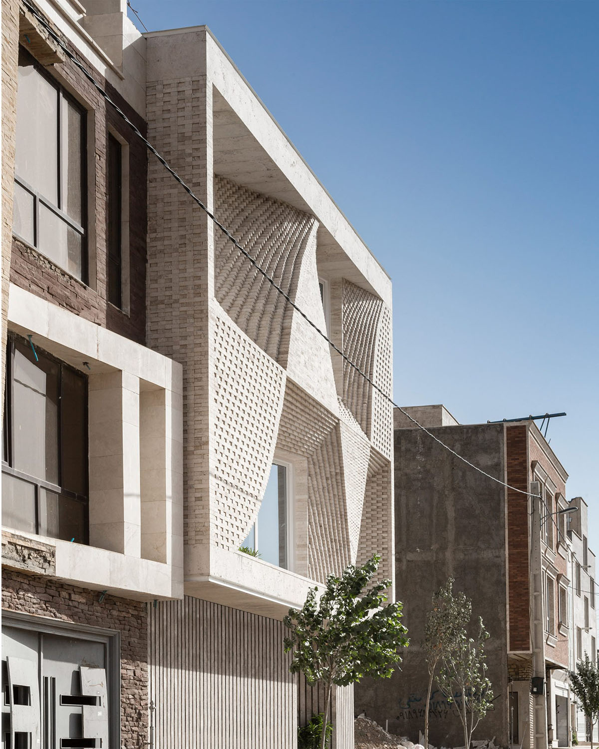 CAAT Studio creates spatial variations of stone on the facade of this Iranian residential building