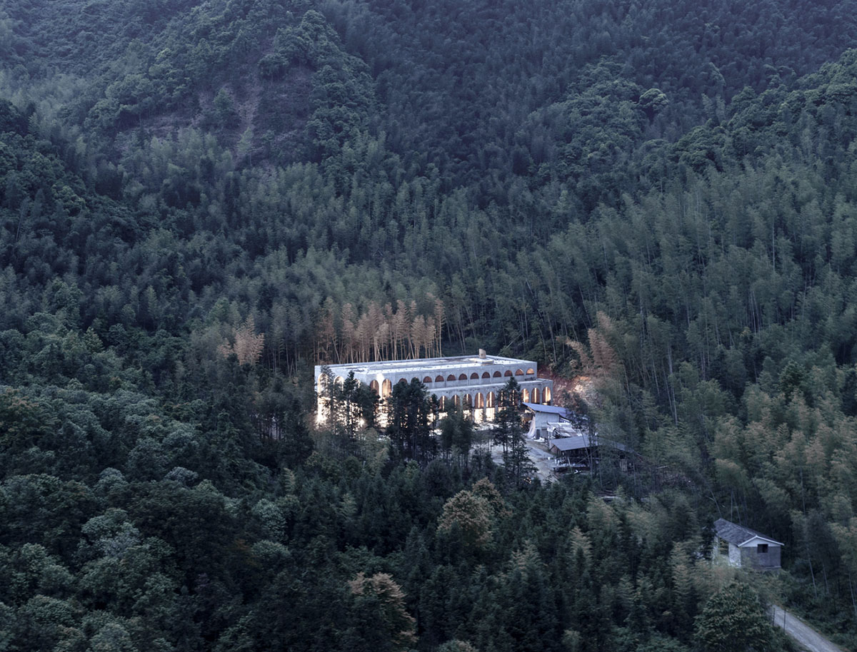 AZL Architects renovates old kiln building with concrete and brick arches in the middle of a forest