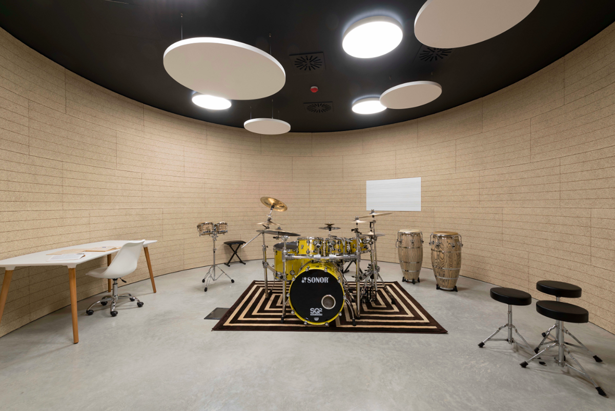 Nine wooden circular music boxes by MCA placed on the former Lamborghini manufacturing site in Italy