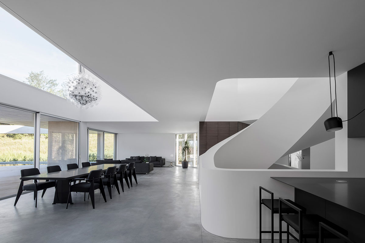 Grey concrete villa by DF_DC is characterised with trapezoidal colonnaded terrace on Comano hills