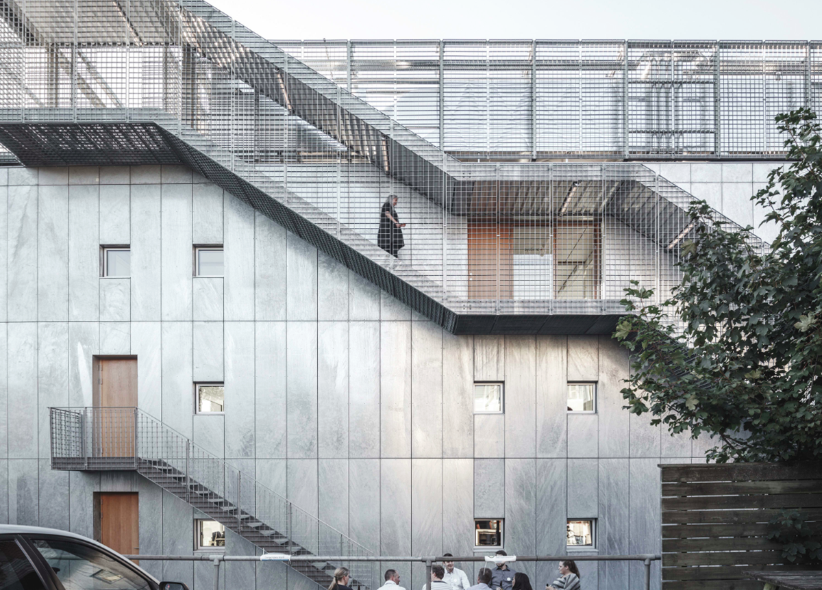 A collage of elements reflecting surroundings assembled on the facade of Office Building by SLETH