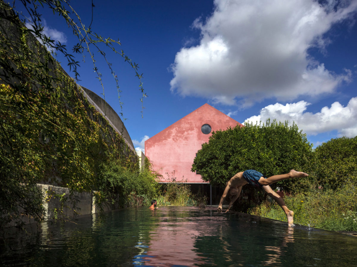 Extrastudio converted former winery in Portugal  into a new family home with red mortar walls