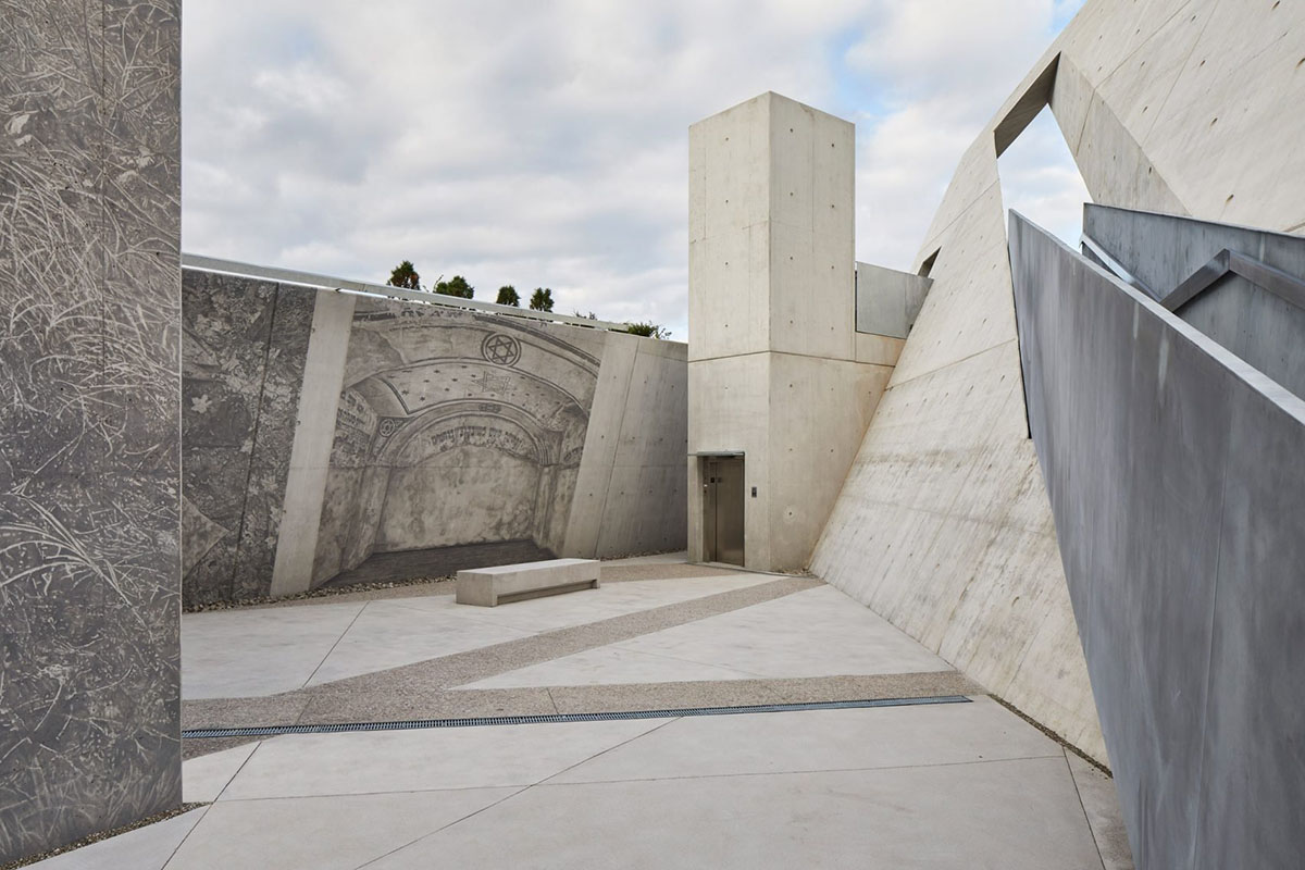 Daniel Libeskind’s Holocaust Monument features fragmented concrete walls creating rough landscape